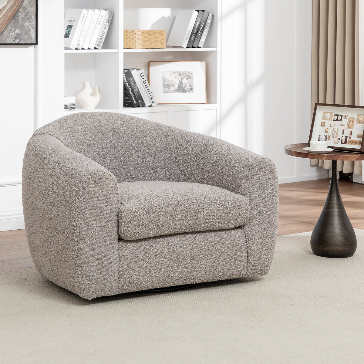 The Avriio Madrid Taupe Fabric Swivel Armchair, featuring soft textured fabric and a modern design, sits elegantly in any bright living room. Enjoy effortless home delivery and white glove setup for a seamless experience.