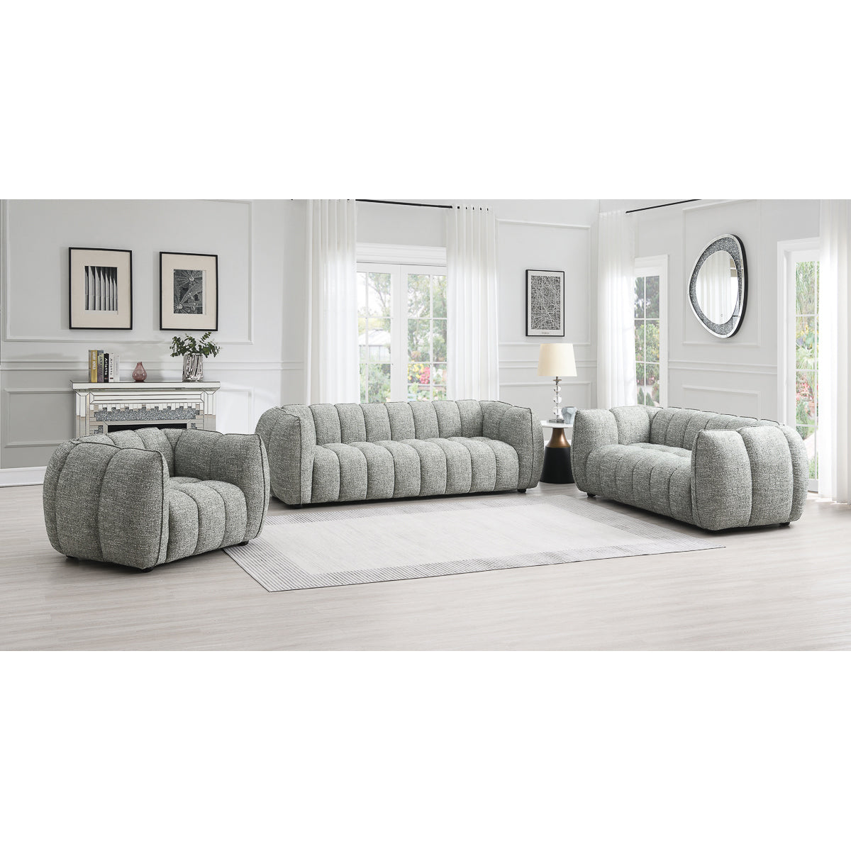 
                  
                    A modern living room featuring the Avriio Vienna Fluted 3 Seater Winter Moss Fabric Sofa on a light rug. Enjoy home delivery and white glove options, set by large windows, white walls, framed art, and a sleek console table.
                  
                